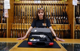 Jen Lavigne, co-owner of That Hunting Store, poses for portrait with a Ruger GP100 Magnum 357, on June 3, 2022 in Ottawa, Canada. - Canadians rushed to buy handguns this week, after Prime Minister Justin Trudeau announced on May 30, 2022, a proposed freeze on sales in the wake of recent mass shootings in the US. "Sales have been brisk," said Lavigne. "We sold 100 handguns or almost our entire stock in the last three days since the prime minister announced the freeze," she said. -- Photo: Dave Chan / AFP