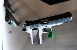 A Springfield Armory 1911 Ronin handgun in 9mm is displayed during the National Rifle Association (NRA) Annual Meeting at the George R. Brown Convention Center, in Houston, Texas on May 28, 2022: a 26 year old man killed by their son with an unattended gun was thought to have first killed himself -- Photo: Patrick T. Fallon / AFP