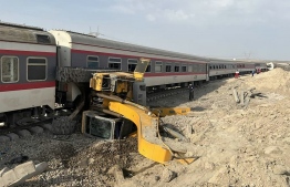 A handout picture made available by the Iranian Red Crescent on June 8, 2022 shows a train derailed after hitting an excavator near the central Iranian city of Tabas, on the line between the cities of Mashhad and Yazd. - More than a dozen people were killed and injured when a train derailed near Tabas after hitting an excavator, state media reported. -- Photo: Iranian Red Crescent / AFP