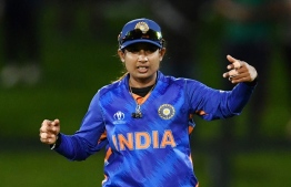 (FILES) In this file photo taken on March 27, 2022, India's captain Mithali Raj reacts during the women's Cricket World Cup match between South Africa and India at Hagley Oval in Christchurch. - Indian women's cricket star Raj on June 8, 2022 announced her retirement from all forms of international cricket after over two decades of dominating the sport as a batter and leader. (Photo by Sanka Vidanagama / AFP)
