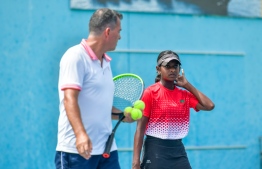 Maldives National Tennis teams coach (Left)  instructing Aara -- Photo: Fayaaz Moosa