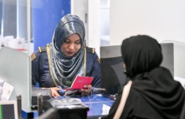 A Maldives Immigration officer ensures validity of a passport application before issuance -- Photo: Nishan Ali/Mihaaru