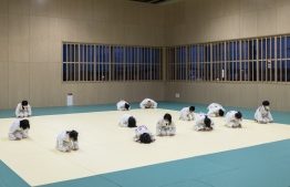 This photo taken on May 25, 2022 shows children taking part in a judo training session in Fukuroi, Shizuoka prefecture. - Japan is the home of judo but a brutal win-at-all-costs mentality, corporal punishment and pressure to lose weight is driving large numbers of children to quit the sport. -- Photo: Charly Triballeau / AFP