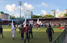 Protesters urging yoga attendees to vacate the premises of Galolhu Football stadium amid meditation session--