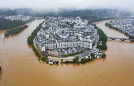 This aerial photo taken on June 20, 2022 shows flooded streets and buildings following heavy rains in Wuyuan, in China's central Jiangxi province. -- Photo: CNS / AFP