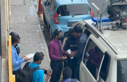 (FILE) Ahmed Ismail escorted by the police after he was arrested on June 26, 2022: he was released on October 12, 2023 as the state had not provided sufficient data to prove the charges pressed against him -- Photo: Mihaaru