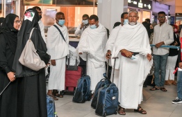 Pilgrims in their pilgrimage garb waiting at the Velana International Airport terminal before embarking on the holy journey -- Photo: Nishan Ali | Mihaaru