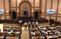 Opposition members standing in front of the Parliament Speaker Nasheed to protest the refusal to accept the emergency motion submitted -- Photo: Parliament