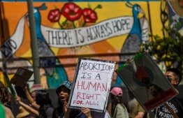 (FILE) Protesters walk past a mural reading "there's always hope" during a demonstration in downtown Los Angeles on June 26, 2022, two days after the US Supreme Court released a decision on Dobbs v Jackson Women's Health Organization, striking down the right to abortion. -- Photo: Apu Gomes / AFP