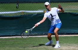 Serbia's Novak Djokovic returns the ball during a training session during the 2022 Wimbledon Championships at The All England Tennis Club in Wimbledon, southwest London, on June 26, 2022. -- Photo: Glyn KIRK / AFP