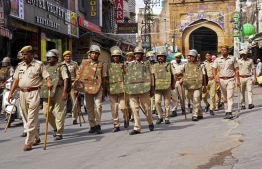 Policemen carry out a flag march through a street in Ajmer on June 29, 2022, following the alleged murder of a Hindu tailor by two Muslim men in Udaipur. - Western India's Udaipur city was placed under partial curfew to guard against potential sectarian violence after a video purporting to show the attempted beheading went viral. -- Photo: Himanshu Sharma / AFP