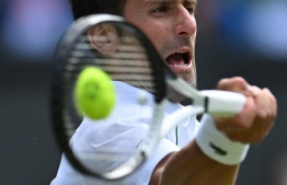Serbia's Novak Djokovic returns the ball to Serbia's Miomir Kecmanovic during their men's singles tennis match on the fifth day of the 2022 Wimbledon Championships at The All England Tennis Club in Wimbledon, southwest London, on July 1, 2022. -- Photo: Glyn Kirk / AFP