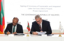 Finance Minister Ibrahim Ameer (L) signs with World Bank's Country Director for Maldives Faris Hadd-Zavos -- Photo: Economic Ministry