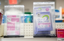 (FILES) In this file photo taken on June 29, 2022 Plan B and Aftera sit locked on a shelf in a pharmacy in Washington, DC. - The US Supreme Court ruling that overturned the right to abortion spurred a rush to prepare for an America where the procedure is banned in many states. -- Photo: Stefani Reynolds / AFP