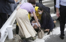 Moments after the former Japanese PM was shot twice by a lone gunman--