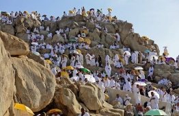 Muslim pilgrims gather atop Mount Arafat, also known as Jabal al-Rahma (Mount of Mercy), southeast of the Saudi holy city of Mecca, during the climax of the Hajj pilgrimage, early on July 8, 2022. (Photo by Christina ASSI / AFP)