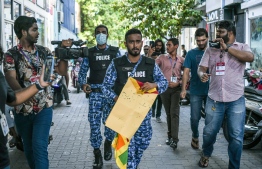 Police confiscates a  Sri Lankan protester's banners and flags  during the protest against President Gotabaya Rajapakse -- Photo: Nishan Ali/ Mihaaru