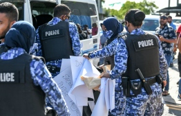 Police confiscates  Sri Lankan protester's’ banners and flags  during the protest against President Gotabaya Rajapakse in Male’-- Photo: Nishan Ali/ Mihaaru