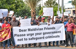 Protesters hold banners during the protest in Male', calling Maldivian government not to protect Sri Lankan President Gotobaya Rajapakse, on Wednesday, July 13, 2022 -- Photo: Nishan Ali/ Mihaaru