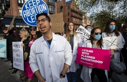 In this file photo taken on May 03, 2022, a group of doctors and medical workers join protesters in front of the State House to show support and rally for abortion rights in Boston, Massachusetts. - The US Supreme Court overturned the Roe v. Wade ruling on June 24 and us states quickly moved to restrict the procedure, sometimes only with exceptions for medical necessity. Doctors across the country were thrust into an ambiguous legal landscape they say threatens both their ability to do their jobs and their patients' health. -- Photo: Joseph Prezioso / AFP