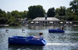 People use pedalos on the Serpentine lake in Hyde Park in west London, on July 19, 2022 as the country experiences an extreme heat wave. - Britain on Tuesday recorded its first ever temperature exceeding 40 degrees Celsius (104 degrees Fahrenheit), with the mercury provisionally registering 40.2C at Heathrow Airport, the country's meteorological agency the Met Office said. -- Photo: Niklas Halle'n / AFP