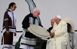 Pope Francis meets Inuit drum dancers at Nakasuk Elementary School Square in Iqaluit, Nunavut, Canada, on July 29, 2022. - Pope Francis flew to the Canadian Arctic Friday to meet Inuit survivors of Catholic-run schools where Indigenous children were abused over a span of decades, in the final stop of a landmark tour apologizing for the Church's role.
The 85-year-old pontiff travelled to the vast northern territory of Nunavut's capital, Iqaluit, which means "the place of many fish." Residents greeted him with traditional music including throat singing on a stage set up beneath an overcast sky. -- Photo: Vincenzo Pinto / AFP
