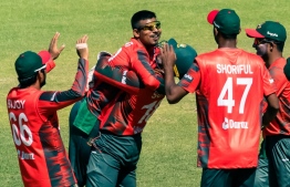 Bangladesh captain Quazi Nurul Hasan Sohan (C) lifts his bowler Musaddek Hossain (2nd L) on getting five wickets in action during the second T20 cricket match played between Bangladesh and hosts Zimbabwe, on July 31 2022 at the Harare Sports Club. -- Photo: Jekesai Njikizana / AFP