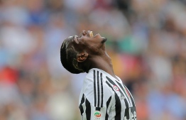 (FILES) In this file photo taken on April 17, 2016 Juventus' midfielder Paul Pogba from France reacts during the Italian Serie A football match Juventus vs Palermo at the Juventus stadium in Turin. -- Photo: Marco Bertorello / AFP