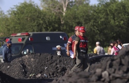Rescue personnel work in the area of an accident at a coal mine, following a collapse which left -up to now- nine miners trapped, in the Agujita area, Sabinas municipality, Coahuila state, Mexico, on August 3, 2022. --Photo: Marcos Gonzalez / AFP