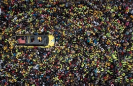 This aerial view shows Kenya's Deputy President and presidential candidate William Ruto of Kenya Kwanza (One Kenya) political party coalition speaking to supporters from a car during his rally in Thika, Kenya, on August 3, 2022. -- Photo: Yasuyoshi Chiba / AFP