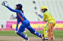 Australia's Rachael Haynes (R) wtaches as India's Yastika Bhatia attempts to catch the ball  during the women's Twenty20 cricket match between Australia and India on day one of the Commonwealth Games at Edgbaston in Birmingham, central England, on July 29, 2022. -- Photo: Glyn Kirk / AFP