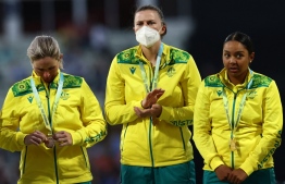 Gold medalists team Australia, including Australia's Tahlia McGrath (C) wearing a face mask, stand on the podium during the medal ceremony for the women's Twenty20 Cricket on day ten of the Commonwealth Games at Edgbaston in Birmingham, central England, on August 7, 2022. -- Photo: Darren Staples / AFP