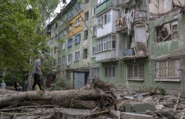 Local residents look at the damages after an early morning Russian forces' strike in Kostiantynivka, eastern Ukraine, amid the Russian invasion of Ukraine. - In Pokrovsk, 85 kilometres (53 miles) to the south of Kramatorsk, the main city in the Ukrainian-held part of the region, a strike destroyed or damaged a dozen homes on a single street last week.: Immigration Service at Finland said that one third of those fleeing Ukraine to Finland are children -- Photo by Bulent Kilic / AFP