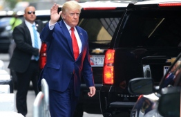 Former US President Donald Trump waves while walking to a vehicle outside of Trump Tower in New York City on August 10, 2022. - Donald Trump on Wednesday declined to answer questions under oath in New York over alleged fraud at his family business, as legal pressures pile up for the former president whose house was raided by the FBI just two days ago. -- Photo: Stringer / AFP