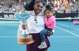 (FILES) In this file photo taken on January 12, 2020 Serena Williams of the US with her daughter Alexis Olympia after her win against Jessica Pegula of the US during their women's singles final match during the Auckland Classic tennis tournament in Auckland. -- Photo: Micheal Bradley / AFP