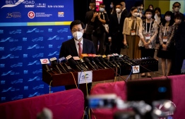 Hong Kong Chief Executive John Lee (centre L) speaks to the media while attending the Belt and Road Summit in Hong Kong on August 31, 2022. -- Photo: Isaac Lawrence / AFP