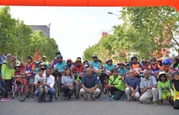 Event participants pose for a photo with President Solih and several state officials at the closing ceremony of the 2019 Mamen Interschool Cycling Competition. -- Photo: Dhiraagu