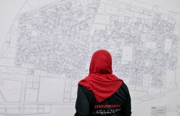 A census enumerator observing a map of Malé at the Census 2022 centre in Hulhumalé on 13th September 2022. PHOTO: MIHAARU