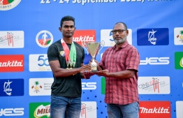 Hassan Saaid (L) accepting the "Best Athlete" trophy; He has won five gold medals during the tournament -- Photo: Nishan Ali