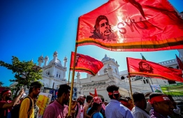 Anti-government demonstrators take part in a protest march in Colombo on September 24, 2022. - Sri Lankan police dispersed hundreds of demonstrators on September 24, a day after severely curtailing protest rights in response to months of unrest sparked by the island nation's sharp economic downturn. (Photo by ISHARA S. KODIKARA / AFP)