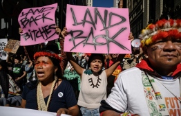 Indigenous community members join activists during a rally organized by youth climate awareness group Fridays for Future to declare a 'climate justice emergency' in New York city on September 23, 2022. (Photo by Ed JONES / AFP)