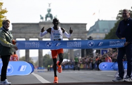 Kenya's Eliud Kipchoge crosses the finish line to win the Berlin Marathon race on September 25, 2022 in Berlin. - Kipchoge has beaten his own world record by 29 seconds, running 2:01:10 at the Berlin Marathon. (Photo by Tobias SCHWARZ / AFP)