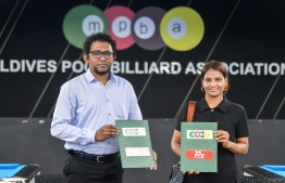 Billiards Association President Ahmed Naseef and Mihaaru Assistant Manager, Sales and Marketing Usha Mahir pose for a photo after signing the media partnership agreement for this year's national billiards tournament -- Photo: Fayaaz Moosa
