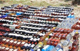 [File] Bottle of Alcohol seized by Police: Two men carrying liquor escape after accident -- Photo: Police