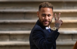 (FILES) In this file photo taken on October 18, 2022 Paris Saint-Germain's Brazilian forward Neymar gestures as he leaves after attending a hearing at the courthouse in Barcelona on October 18, 2022, on the second day of his trial. - Prosecutors in Spain dropped corruption and fraud charges on October 28, 2022 against football star Neymar and others accused in a trial over the Brazilian's 2013 move from Santos to Barcelona. -- Photo: Josep Lago / AFP