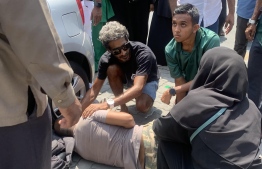 Student and man hailed heroes after they gave first aid to man who had fallen from his motorcycle -- Photo: Shahula Wajeeh's Facebook