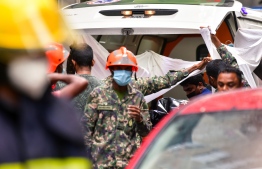 The body of a burnt victim from the Sendrose fire incident being carried to the ambulance on Thursday, November 10 -- Photo: Fayaz Moosa / Mihaaru