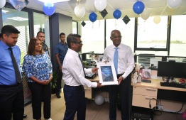 MMPRC employees present President Ibrahim Mohamed Solih with a plaque during his visit to the organization -- Photo: President's Office