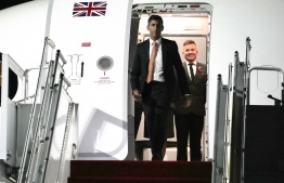 British Prime Minister Rishi Sunak disembarks from an airplane as he arrives at the Ngurah Rai International Airport ahead of the G20 Summit in Bali, Indonesia on November 14, 2022. -- Photo: Firdia Lisnawati /  AFP