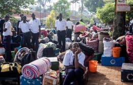 Students wait for their parents with their belongings to leave after a directive of the Health Ministry to close all schools two weeks earlier to curb the spread of Ebola at Naalya Senior Secondary boarding school in Kampala on November 25, 2022. - Since Uganda declared an Ebola outbreak on September 20, cases have spread across the country, including to the capital Kampala and Uganda has been struggling to rein in the outbreak caused by the Sudan strain of the virus, for which there is currently no vaccine. -- Photo: Bardu Katumba / AFP
